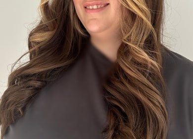 Woman with styled wavy hair at Hair Anthem, Flagstone, Queensland, AU, showcasing voluminous brown curls.