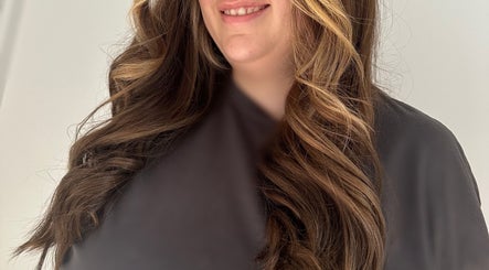 Woman with styled wavy hair at Hair Anthem, Flagstone, Queensland, AU, showcasing voluminous brown curls.