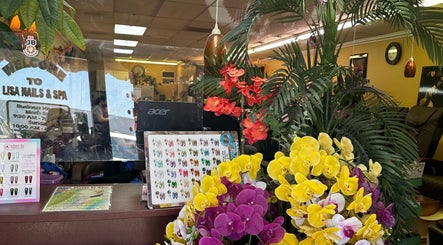Entrance of Lisa Nails and Spa in Sonora, California featuring vibrant orchids and manicure options.