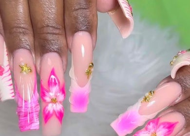 Elegant floral nail art at Lisa Nails and Spa, Sonora, California, US, featuring vibrant pink designs.
