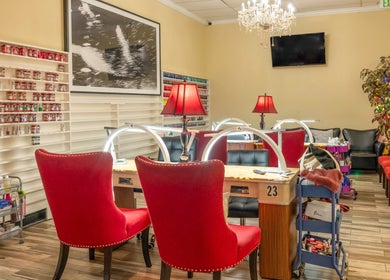 Cozy interior of VIP Nails and Spa Official, Lodi, California, US with red chairs and elegant decor.