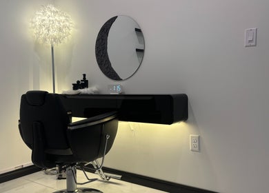 Sleek salon station at KaHBee by Lee in Torrance, California, US featuring a modern chair and illuminated mirror.