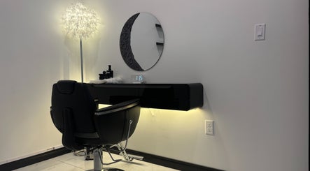 Sleek salon station at KaHBee by Lee in Torrance, California, US featuring a modern chair and illuminated mirror.