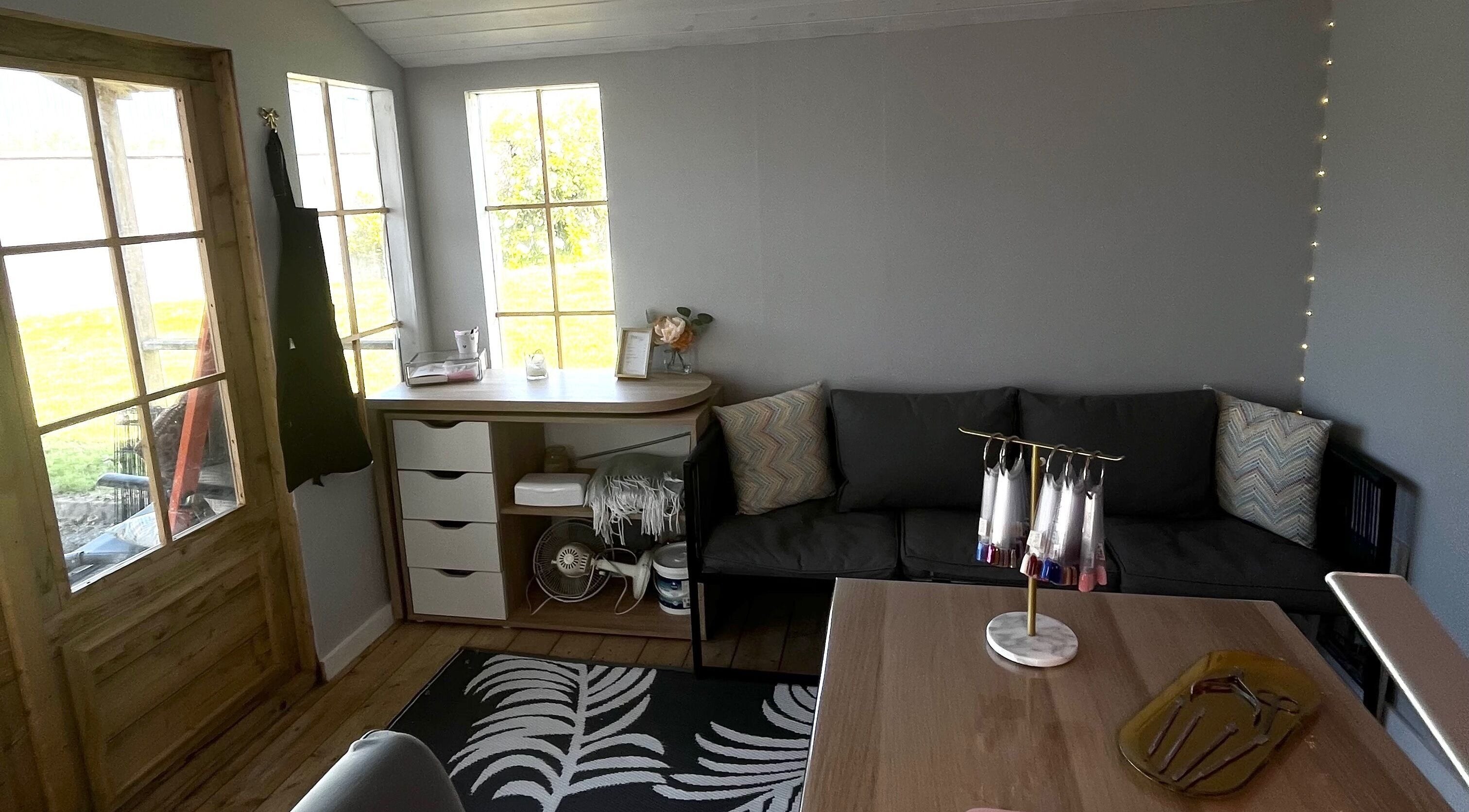 Cozy interior of Nails By Caoimhe in Castlebar, County Mayo, IE, featuring a seating area and nail art display.