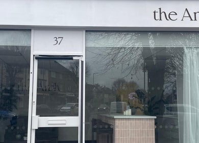 Entrance of Medermica in Bristol, England, GB showcasing modern facade with large glass windows.