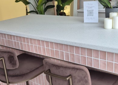 Stylish pink tiled counter with plush chairs at Medermica, Bristol, England, GB offers a welcoming ambiance.