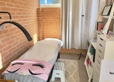 Cozy treatment room at Her Lash Escape, Minto, New South Wales, AU with a relaxing bed and elegant decor.