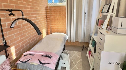 Cozy treatment room at Her Lash Escape, Minto, New South Wales, AU with a relaxing bed and elegant decor.