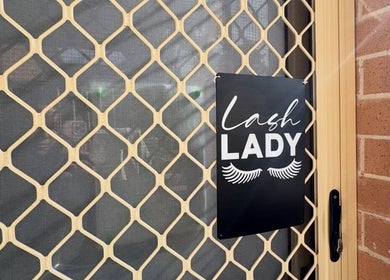 Entrance of Her Lash Escape in Minto, New South Wales, AU with 'Lash Lady' sign on the mesh door.