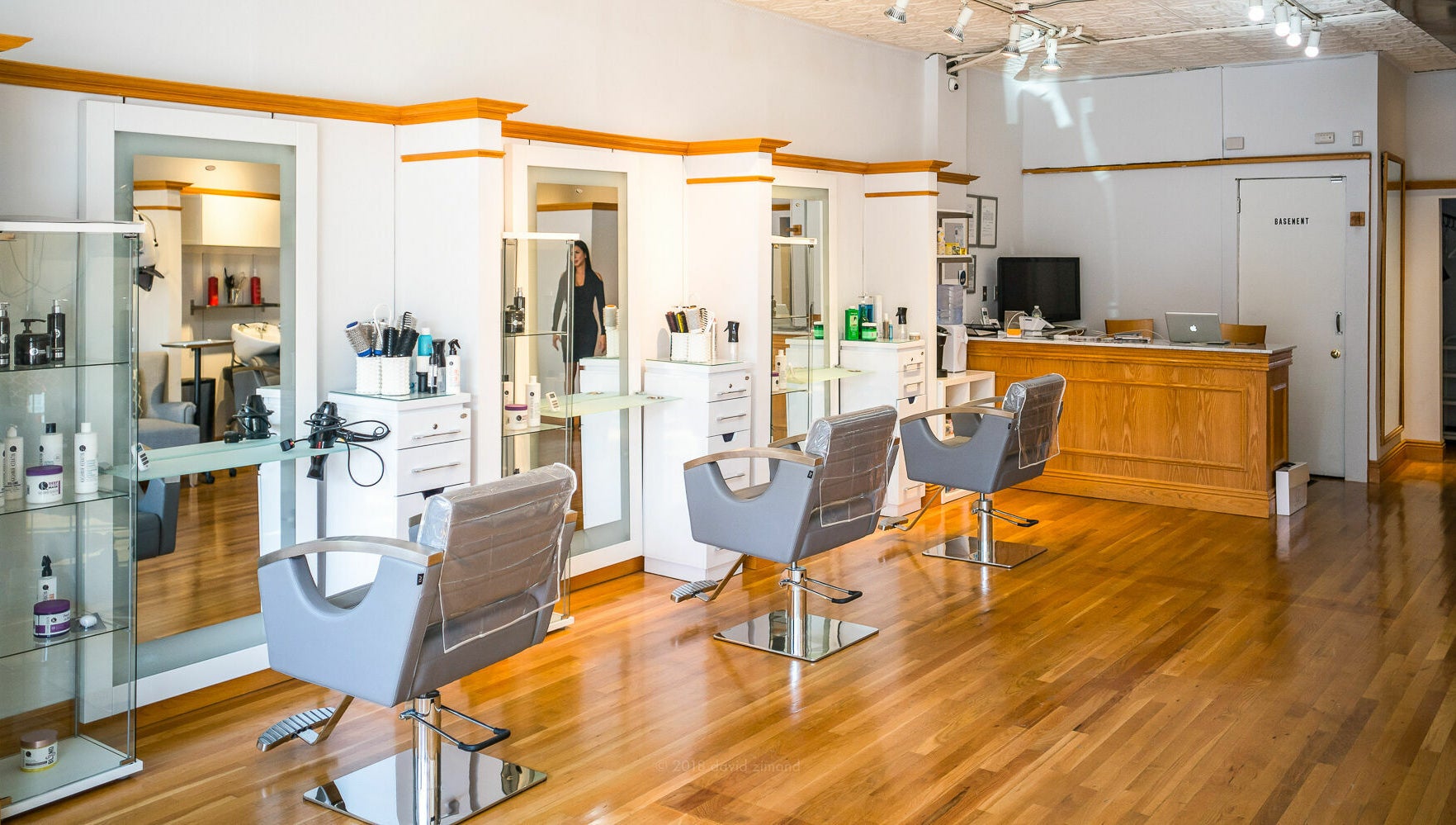 Modern salon interior at DaVinci Hair Studio, Englewood, New Jersey, US with sleek chairs and styling stations.