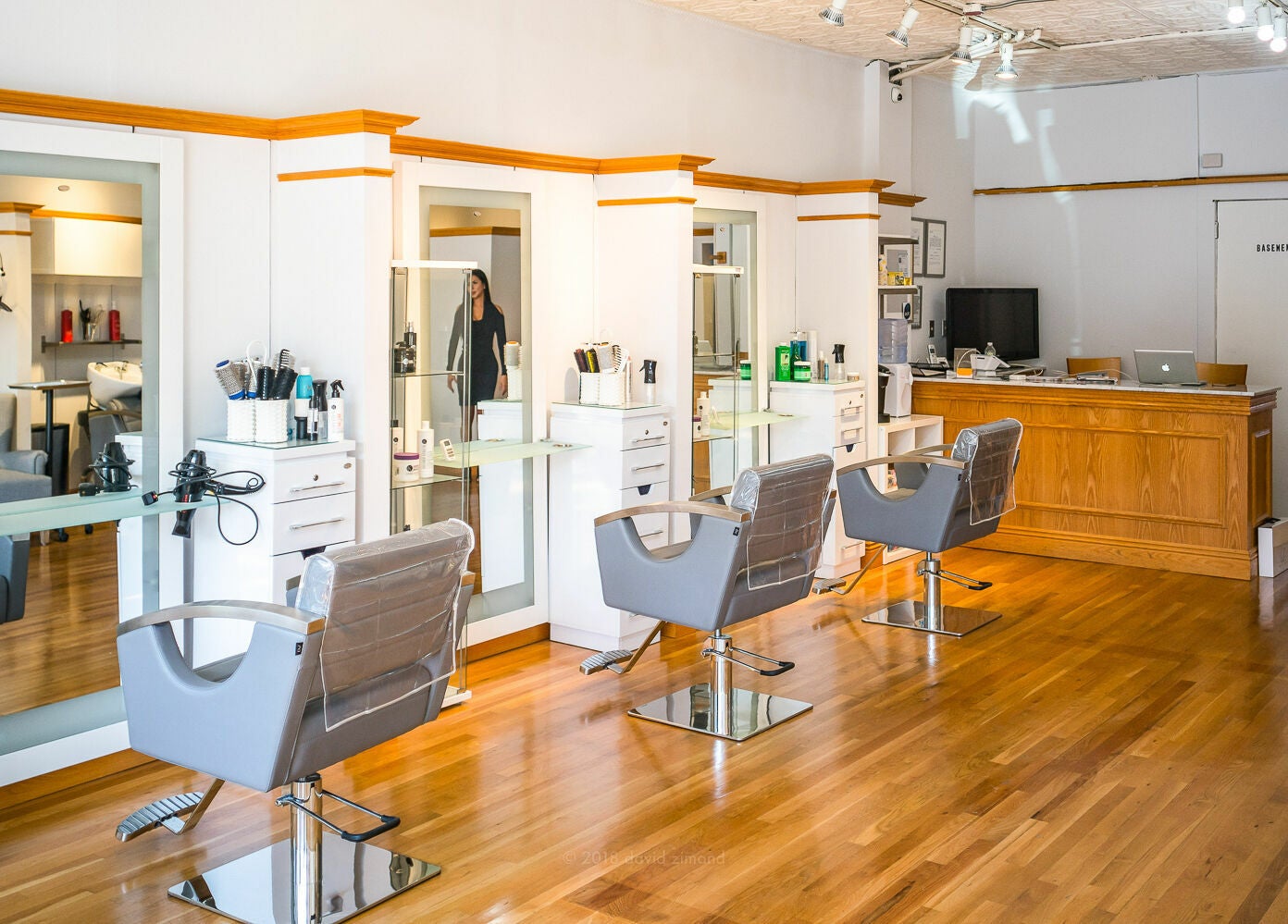 Modern salon interior at DaVinci Hair Studio, Englewood, New Jersey, US with sleek chairs and styling stations.