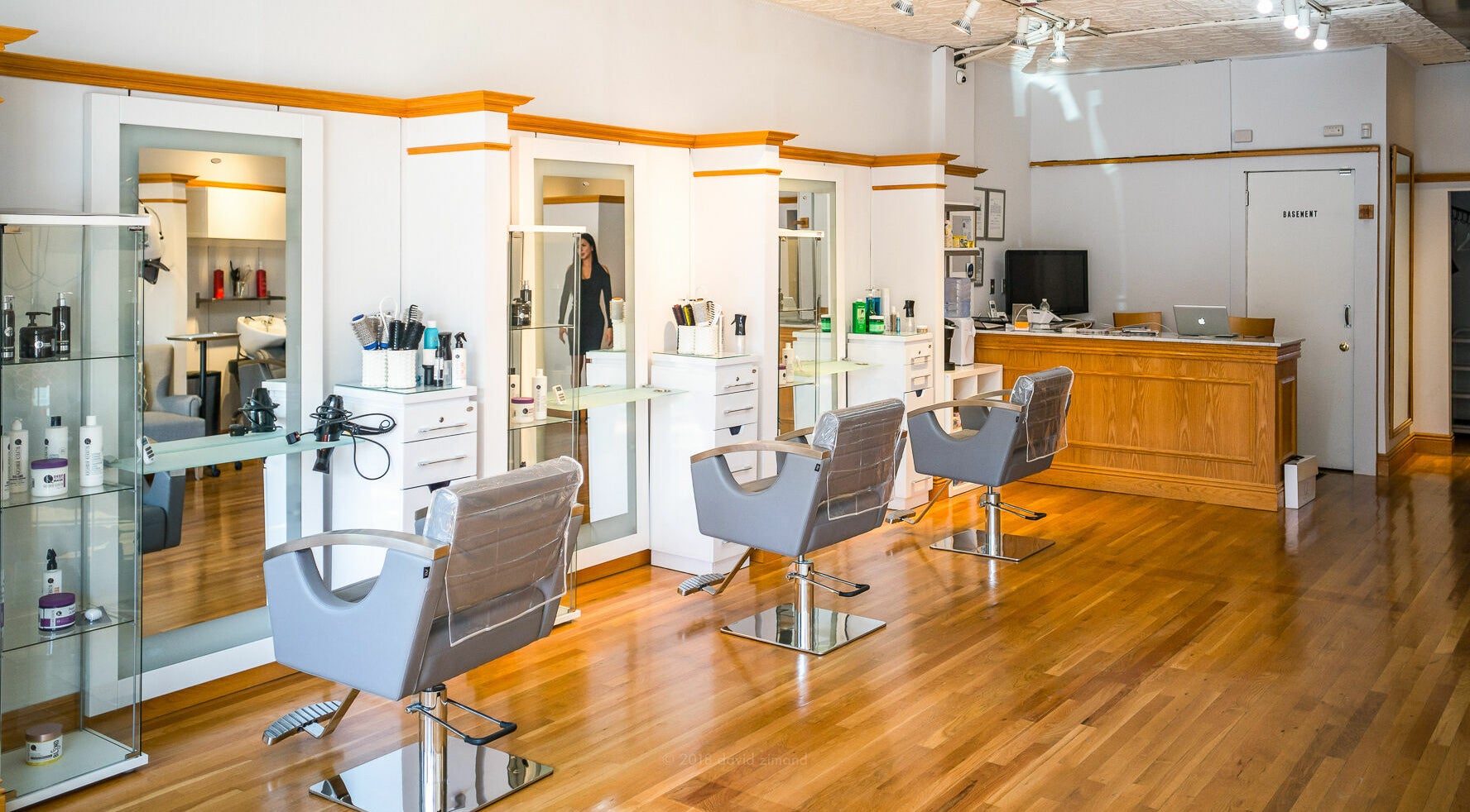 Modern salon interior at DaVinci Hair Studio, Englewood, New Jersey, US with sleek chairs and styling stations.