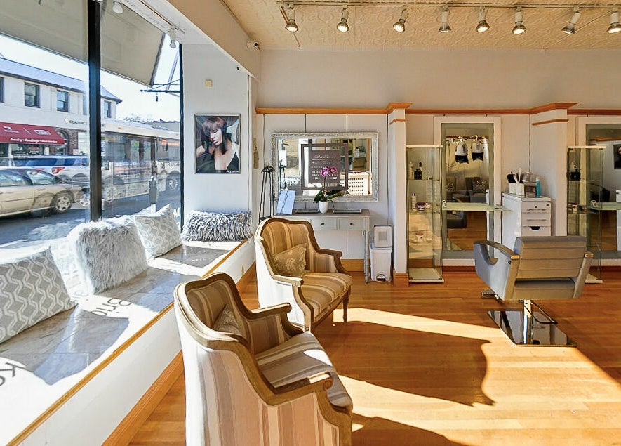 Inviting interior of DaVinci Hair Studio in Englewood, New Jersey, US with stylish chairs and natural light.
