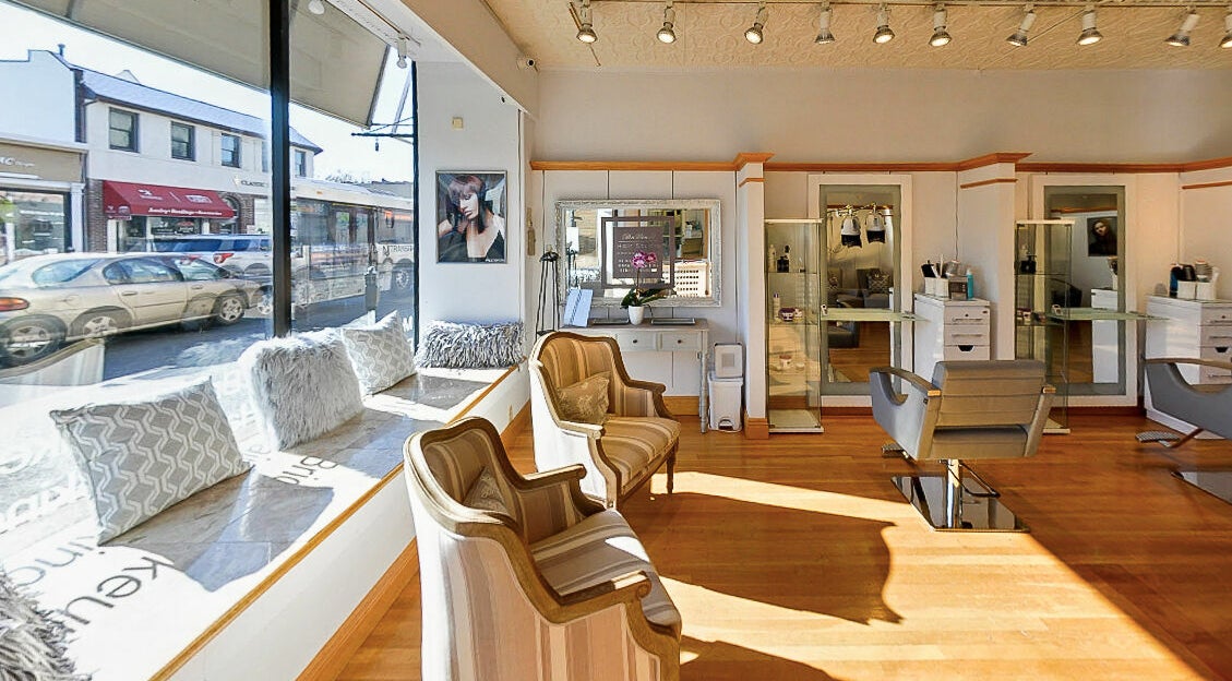 Inviting interior of DaVinci Hair Studio in Englewood, New Jersey, US with stylish chairs and natural light.