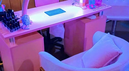 Modern nail care station at AWrelax Spa, Davenport, Iowa, US, featuring vibrant lighting and comfortable seating.