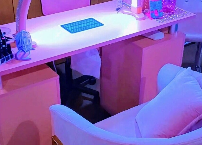 Chic nail station at AW Relax Spa in Davenport, Iowa, US with pink decor and modern amenities.