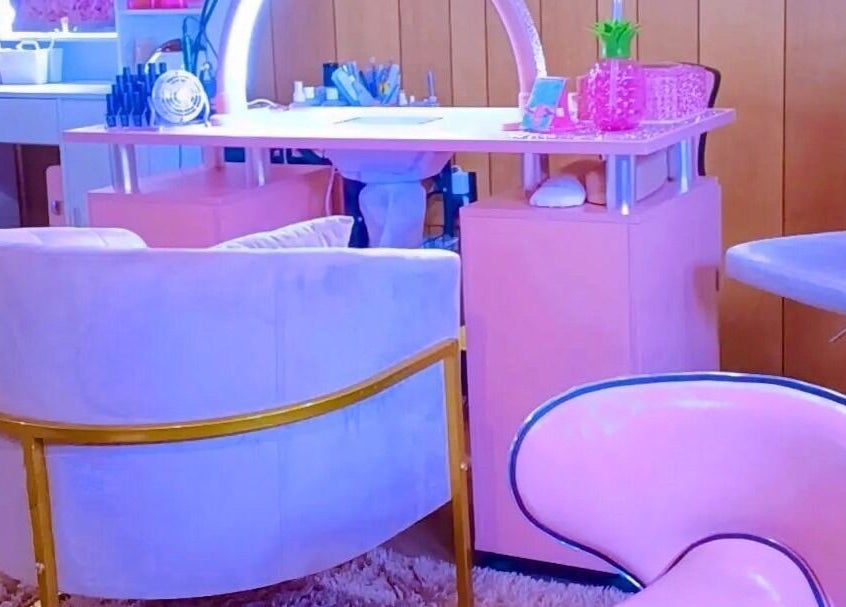Stylish nail salon setting at AW Relax Spa in Davenport, Iowa, US with pink decor and comfortable seating.