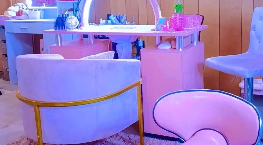 Stylish nail salon setting at AW Relax Spa in Davenport, Iowa, US with pink decor and comfortable seating.