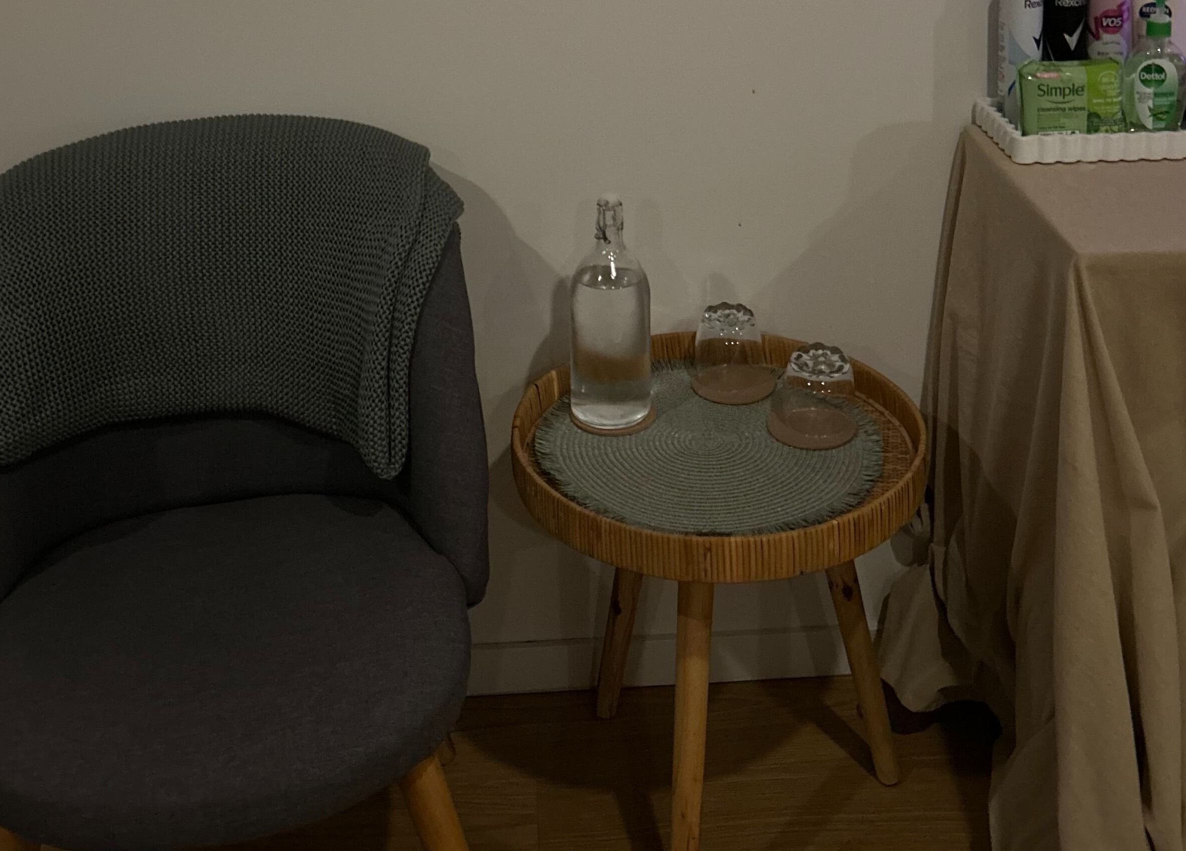 Cozy seating area at Skin Deep Massage Therapy, Crib Point, Victoria, AU with a chair, table, and essentials.