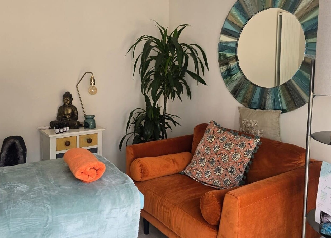 A tranquil space at Fern Wellbeing, Paignton, England, GB featuring a massage bed and cozy decor.