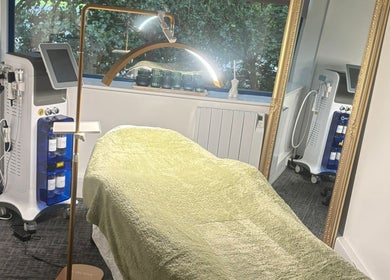 Modern treatment room at Shades of Beauty, Aylesbury, England, GB, featuring state-of-the-art equipment and cozy decor.