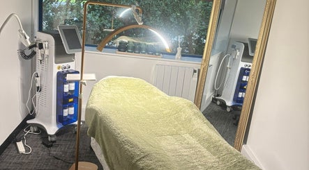 Modern treatment room at Shades of Beauty, Aylesbury, England, GB, featuring state-of-the-art equipment and cozy decor.