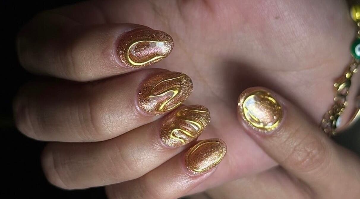Golden nails with artistic design at Stay Classy Clayfield, Clayfield, Queensland, AU.