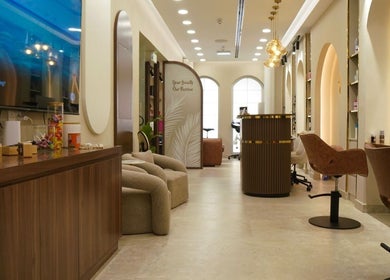 Interior of LBL Salon in Dubai, Dubai, AE showcasing elegant seating and modern decor under warm lighting.