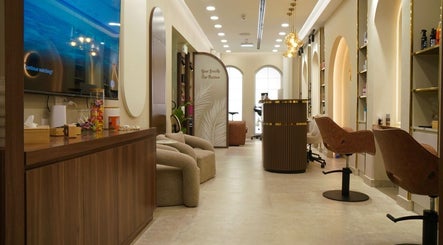 Interior of LBL Salon in Dubai, Dubai, AE showcasing elegant seating and modern decor under warm lighting.