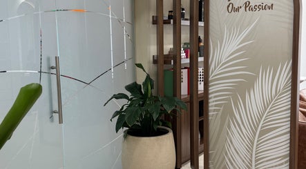 Stylish entrance of LBL Salon in Dubai, Dubai, AE featuring modern decor and a lush green plant.