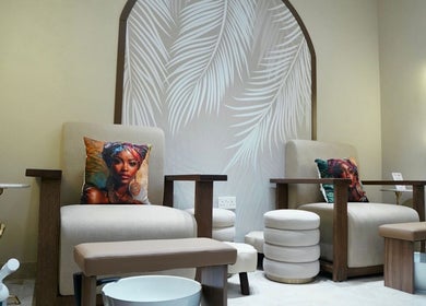 Luxurious seating area at LBL Salon, Dubai, Dubai, AE with stylish decor and plush cushions.