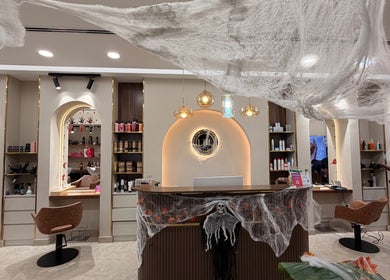Festively decorated reception at LBL Salon in Dubai, Dubai, AE with cobwebs and stylish lighting.