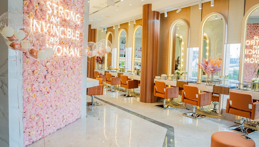 Luxurious interior of Charcole Lovers salon in Colombo, Western Province, LK, featuring pink floral wall.