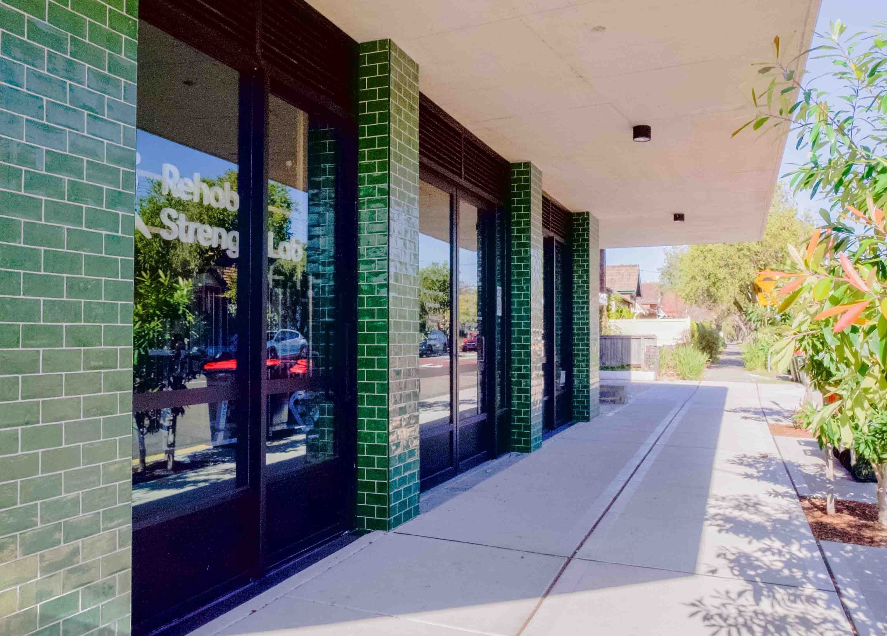 Green-tiled entrance of Hyperflex Sports & Remedial Massage in Hurlstone Park, New South Wales, AU.