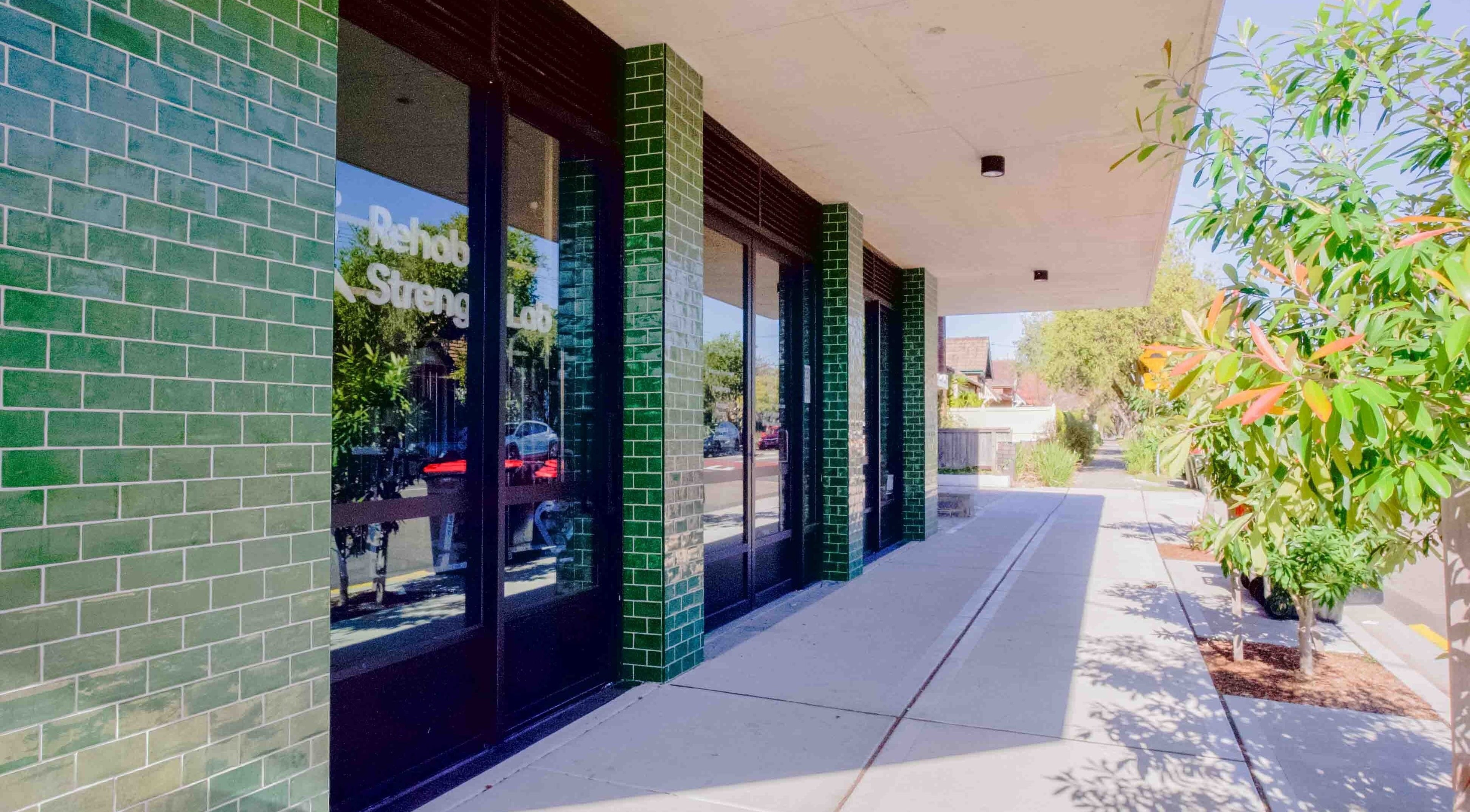 Green-tiled entrance of Hyperflex Sports & Remedial Massage in Hurlstone Park, New South Wales, AU.