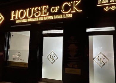 Entrance of House of CK lit at night, captured at At Your Finger Tips, Blantyre, Scotland, GB.