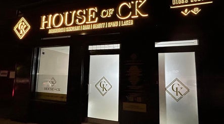 Entrance of House of CK lit at night, captured at At Your Finger Tips, Blantyre, Scotland, GB.