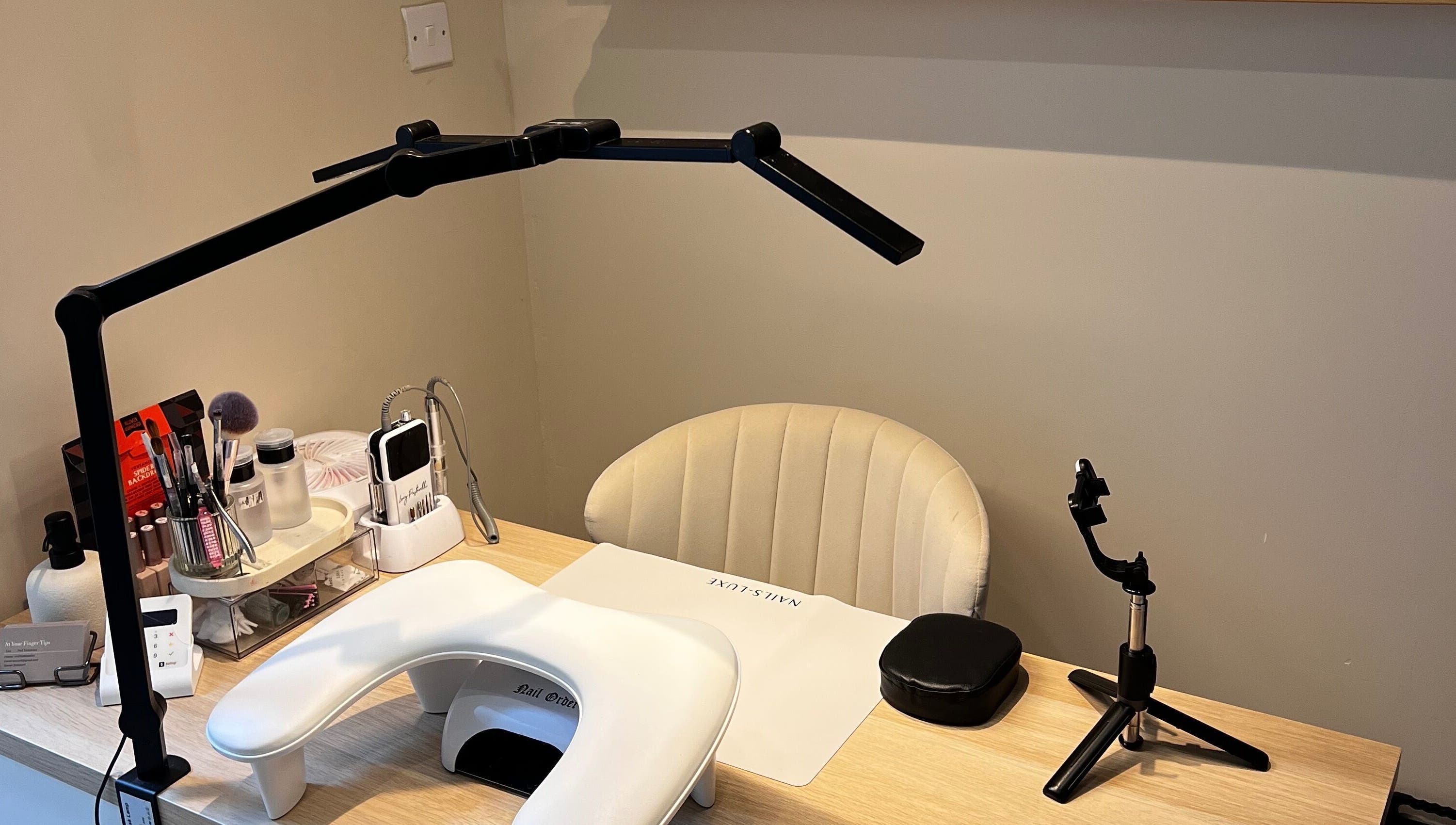 Inviting nail care station at At Your Finger Tips, Cambuslang, Scotland, GB, featuring modern tools and seating.