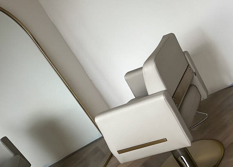 Modern salon chair and sleek mirror at At Your Finger Tips, Cambuslang, Scotland, GB.