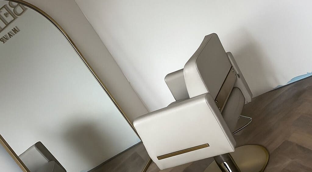 Modern salon chair and sleek mirror at At Your Finger Tips, Cambuslang, Scotland, GB.