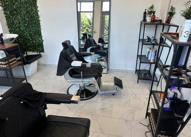 Stylish interior of Újlipót Barber Shop in Budapest, Magyar, HU with chairs and grooming stations.