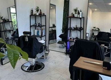 Chic interior of Újlipót Barber Shop in Budapest, Magyar, HU with stylish chairs and equipment.