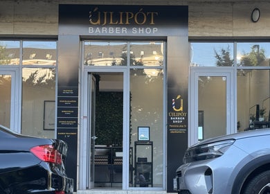 Front entrance of Újlipót Barber Shop in Budapest, Magyar, HU showcasing stylish design and branding.