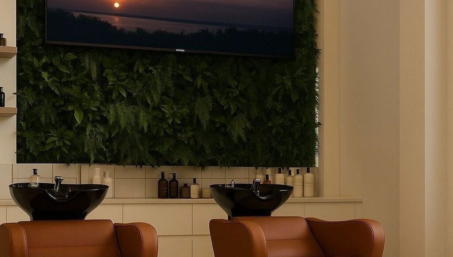 Elegant salon interior at Joe Kerdi Maison Beauté, Dubai, Dubai, AE with plush chairs and lush plant wall.