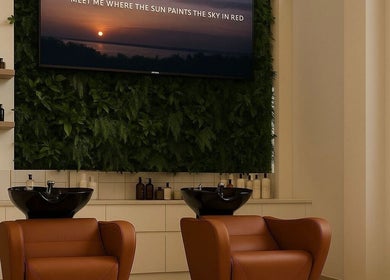 Elegant salon interior at Joe Kerdi Maison Beauté, Dubai, Dubai, AE with plush chairs and lush plant wall.