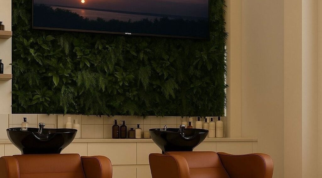 Elegant salon interior at Joe Kerdi Maison Beauté, Dubai, Dubai, AE with plush chairs and lush plant wall.