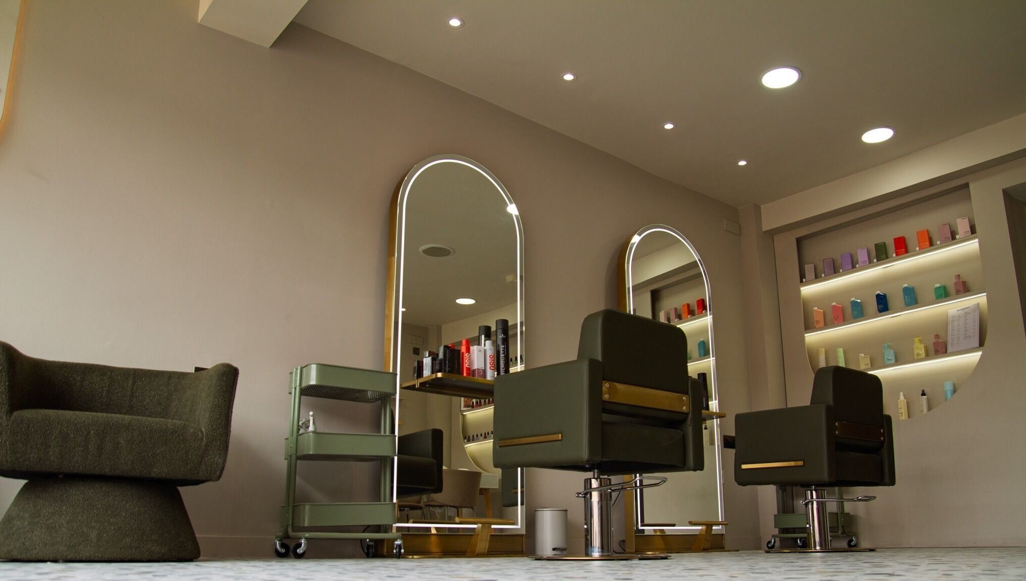 Chic salon interior at Flow, showcasing modern chairs and mirrors in London, England, GB.