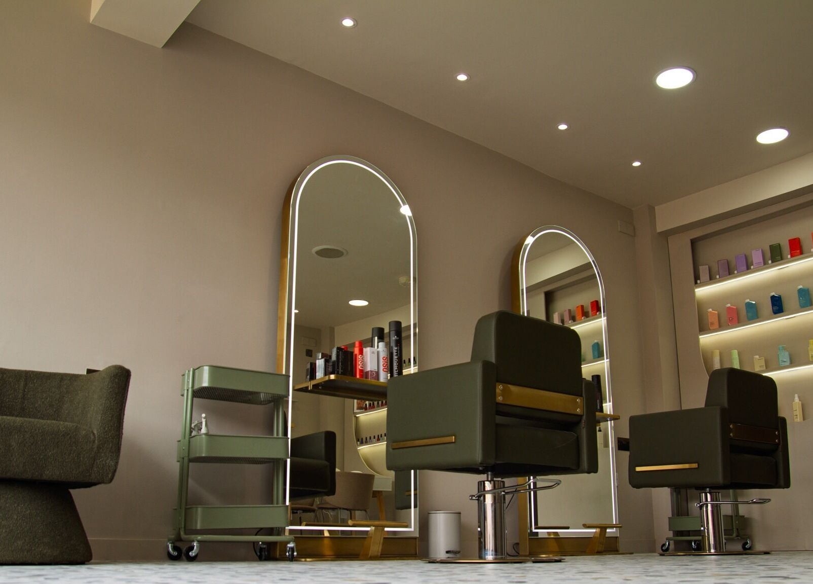 Chic salon interior at Flow, showcasing modern chairs and mirrors in London, England, GB.