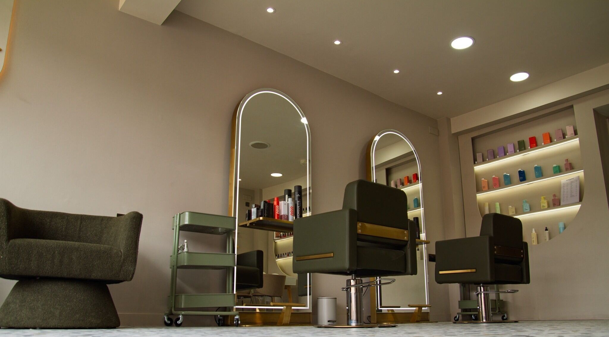 Chic salon interior at Flow, showcasing modern chairs and mirrors in London, England, GB.