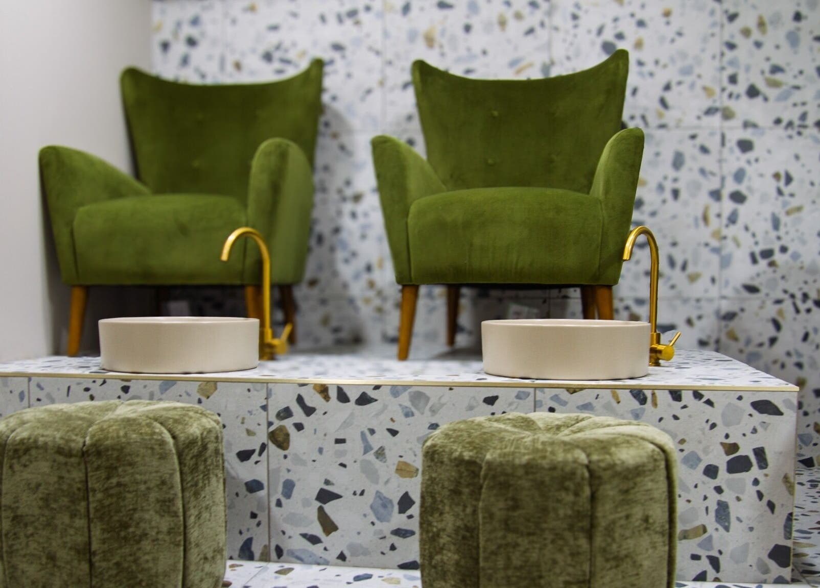 Luxurious green chairs at Flow, London, England, GB, offering a serene pedicure experience.